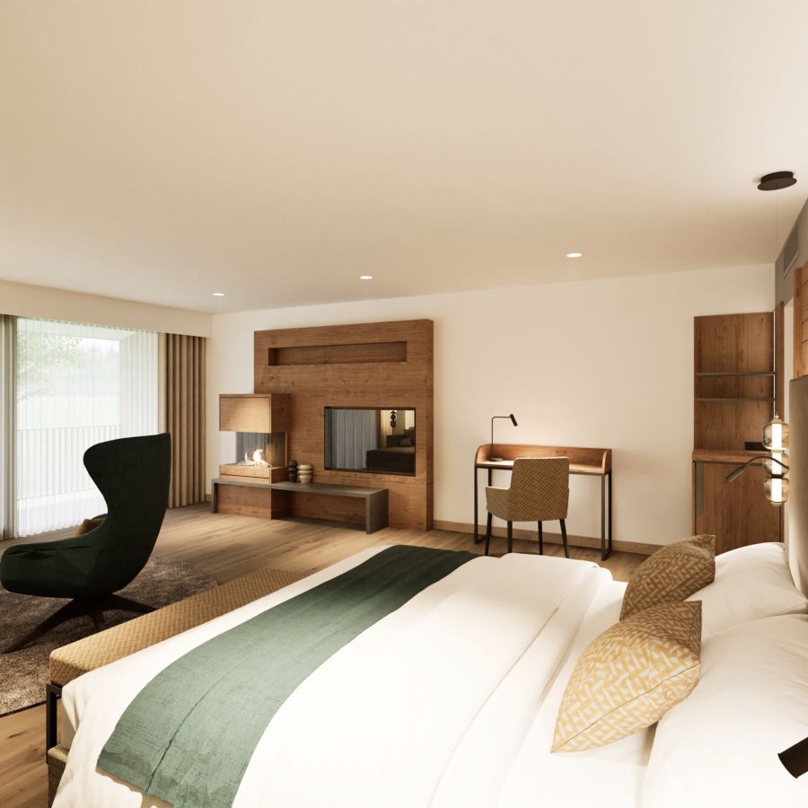 Junior Suite mit Doppelbett, Sessel, Schreibtisch und TV-Wand aus Holz im Hotel Churfürstenhof
