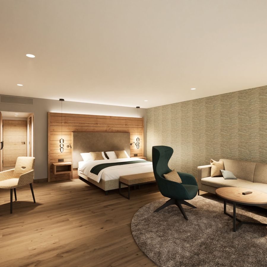 Junior Suite im Hotel Churfürstenhof mit Doppelbett, Ecksofa und Sessel in warmen Naturtönen