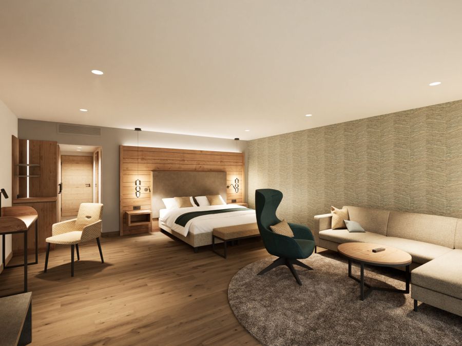 Junior Suite im Hotel Churfürstenhof mit Doppelbett, Ecksofa und Sessel in warmen Naturtönen