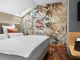 Komfort-Suite mit Doppelbett, floralem Wandbild und Parkettboden im Wellnesshotel Churfürstenhof Bad Birnbach