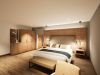 Doppelbett vor Holzwand mit Sitzbank in der Junior Suite des Hotels Churfürstenhof (Visualisierung)