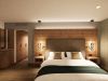 Junior Suite im Hotel Churfürstenhof: Doppelbett vor Holz-Kopfteil mit Pendelleuchten (Visualisierung)