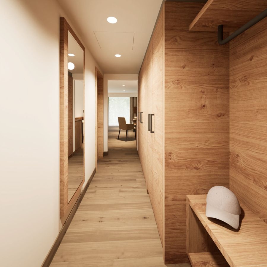 Garderobenbereich der Junior Suite im Hotel Churfürstenhof mit Einbauschrank aus Holz, Spiegel und Ablagen