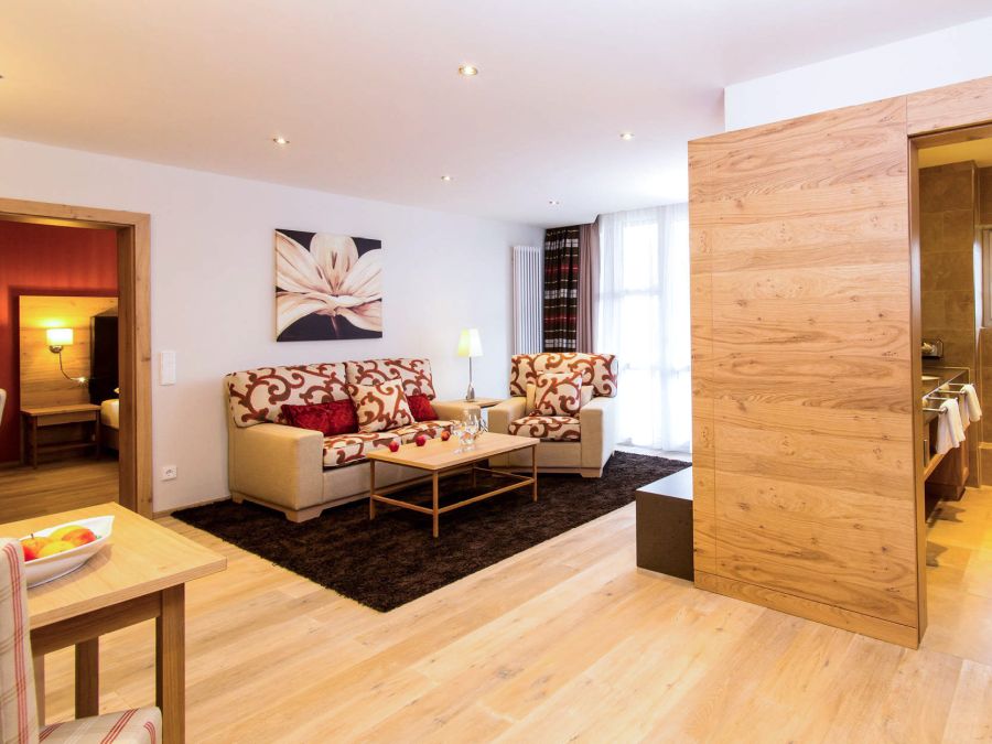 Wohnbereich der Suite Royal im Hotel Churfürstenhof Bad Birnbach mit Sofa, Sesseln und heller Holzeinrichtung